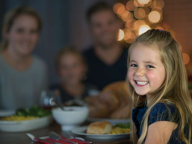 Girl smiling over holiday meal